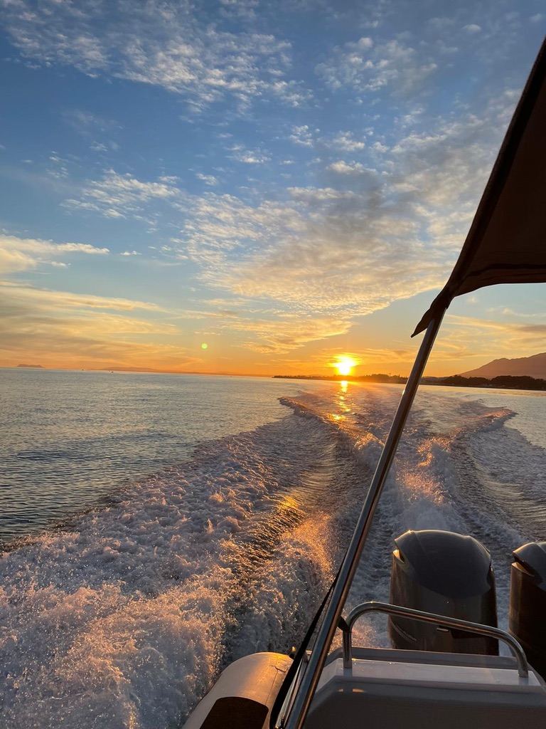Wake behind a boat heading into the sunset off the Marbella coast