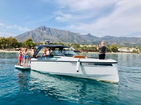 Boat anchored off Marbella with friends swimming