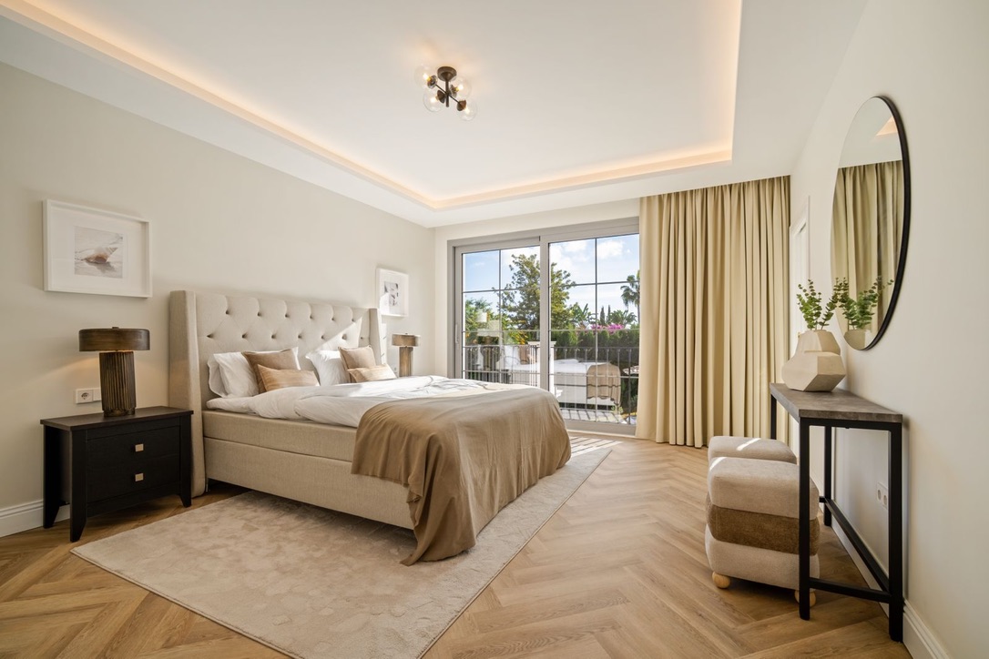 Master bedroom with balcony doors at the Los Arqueros villa