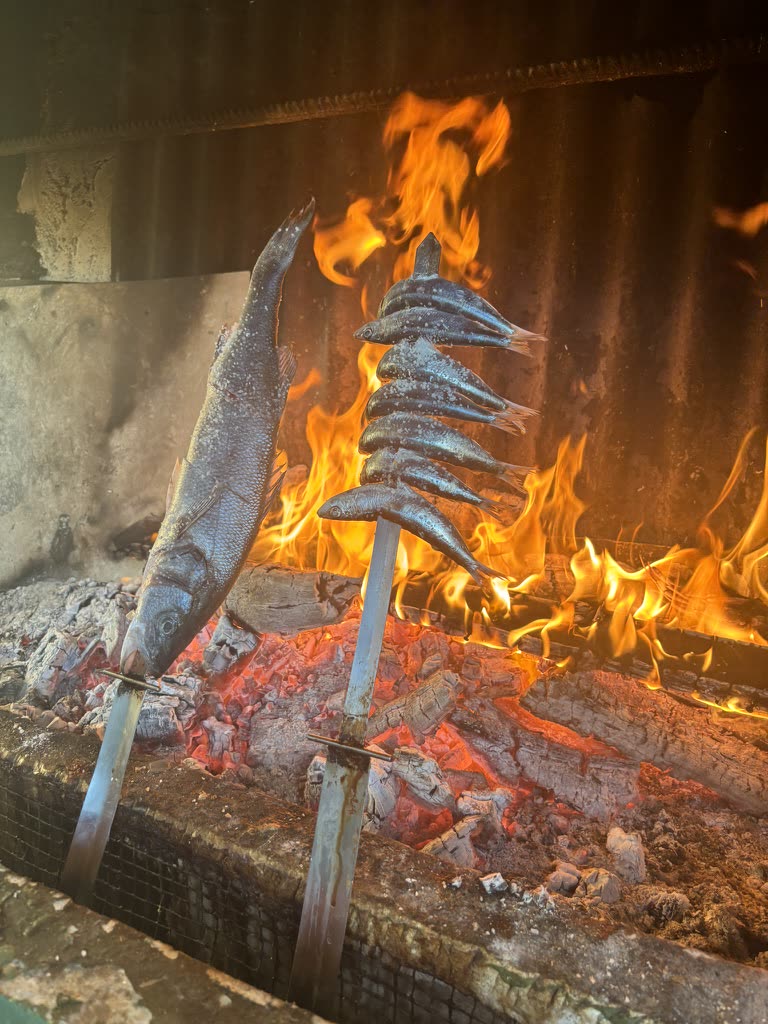 Sardines and sea bass grilled on open fire at a Marbella chiringuito