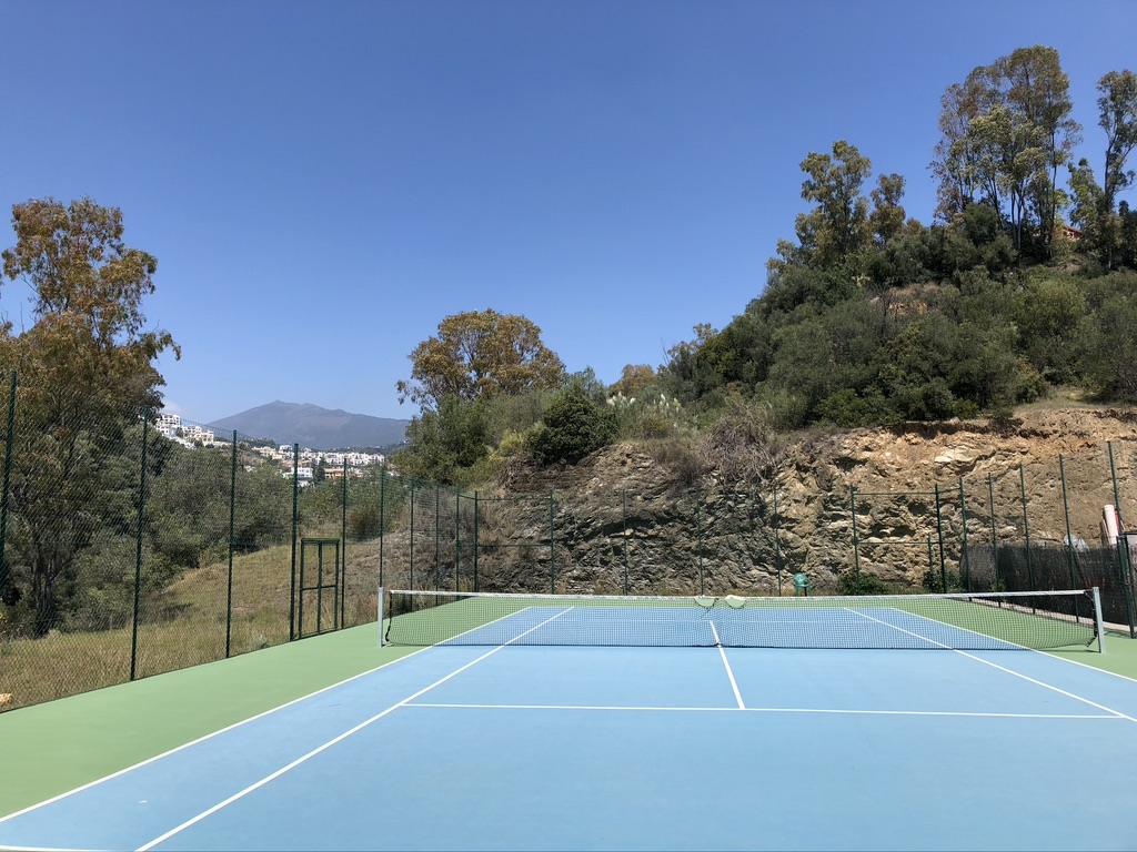 Tennis court in the hills above Marbella with La Concha in the distance